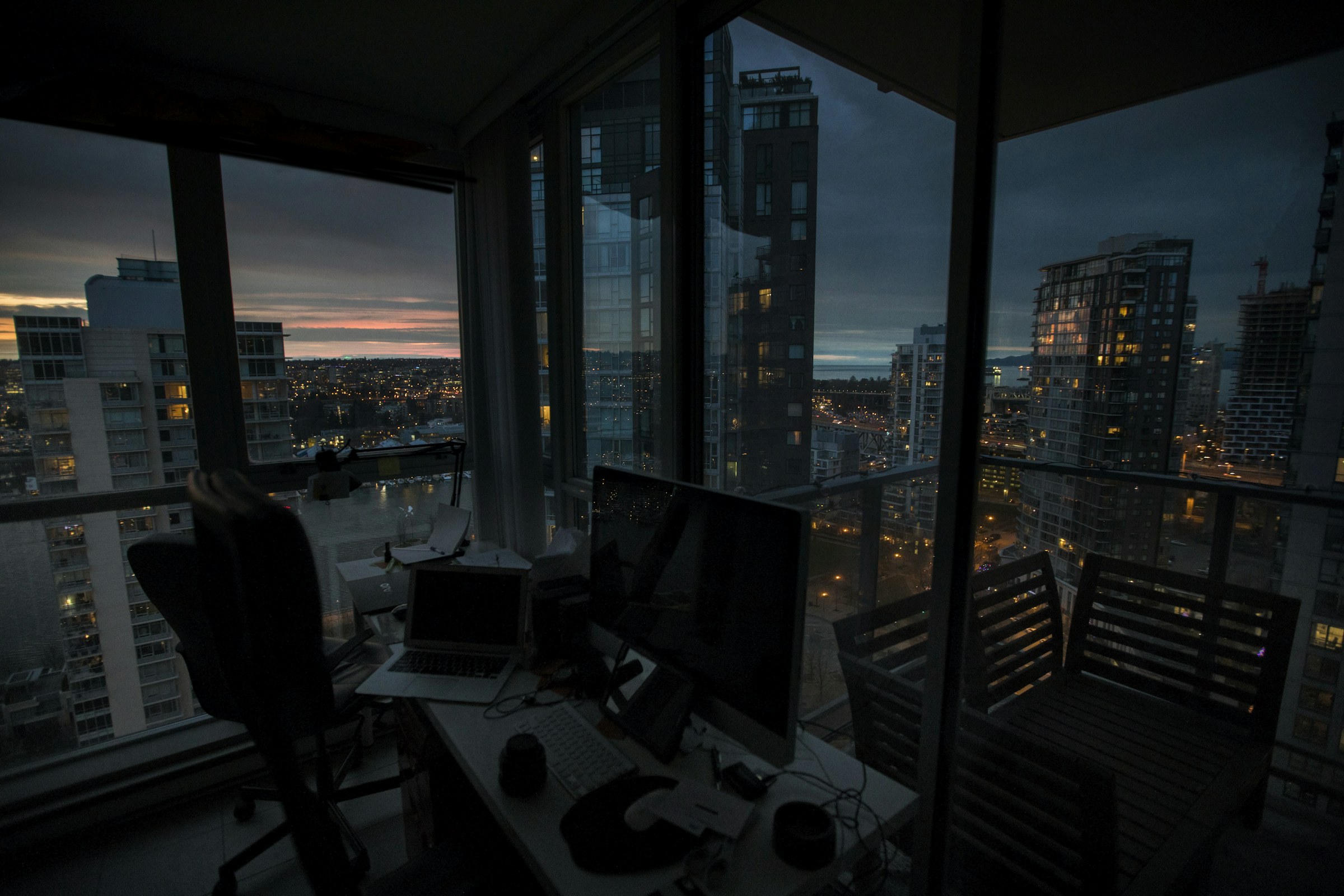 Focused professional workspace overlooking a city before sunrise